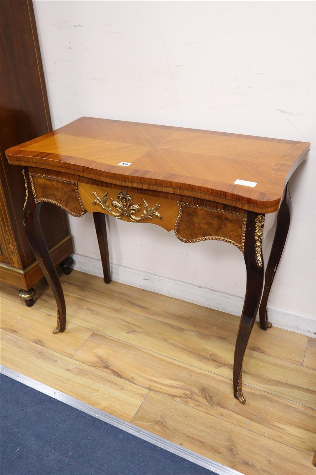 A Louis XV style kingwood serpentine folding card table by H & L Epstein, width 84cm, depth 42cm, height 77cm